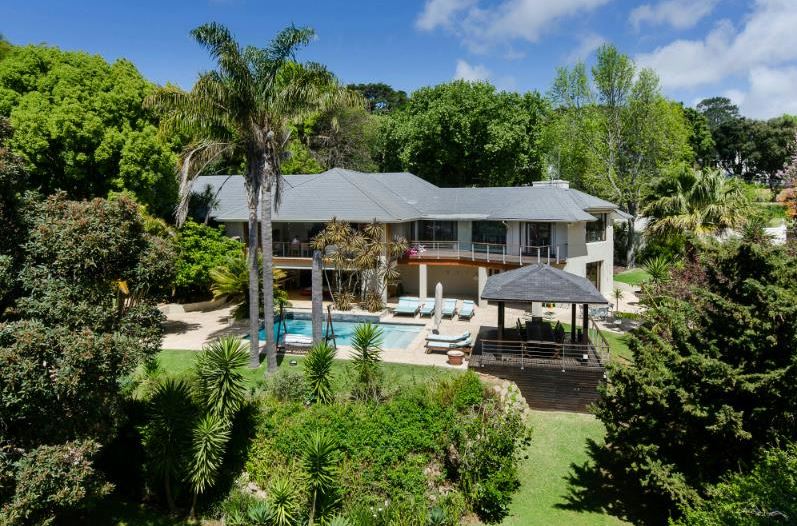 Contemporary home with expansive open spaces and a sleek pool, embodying modern design and indoor-outdoor living.