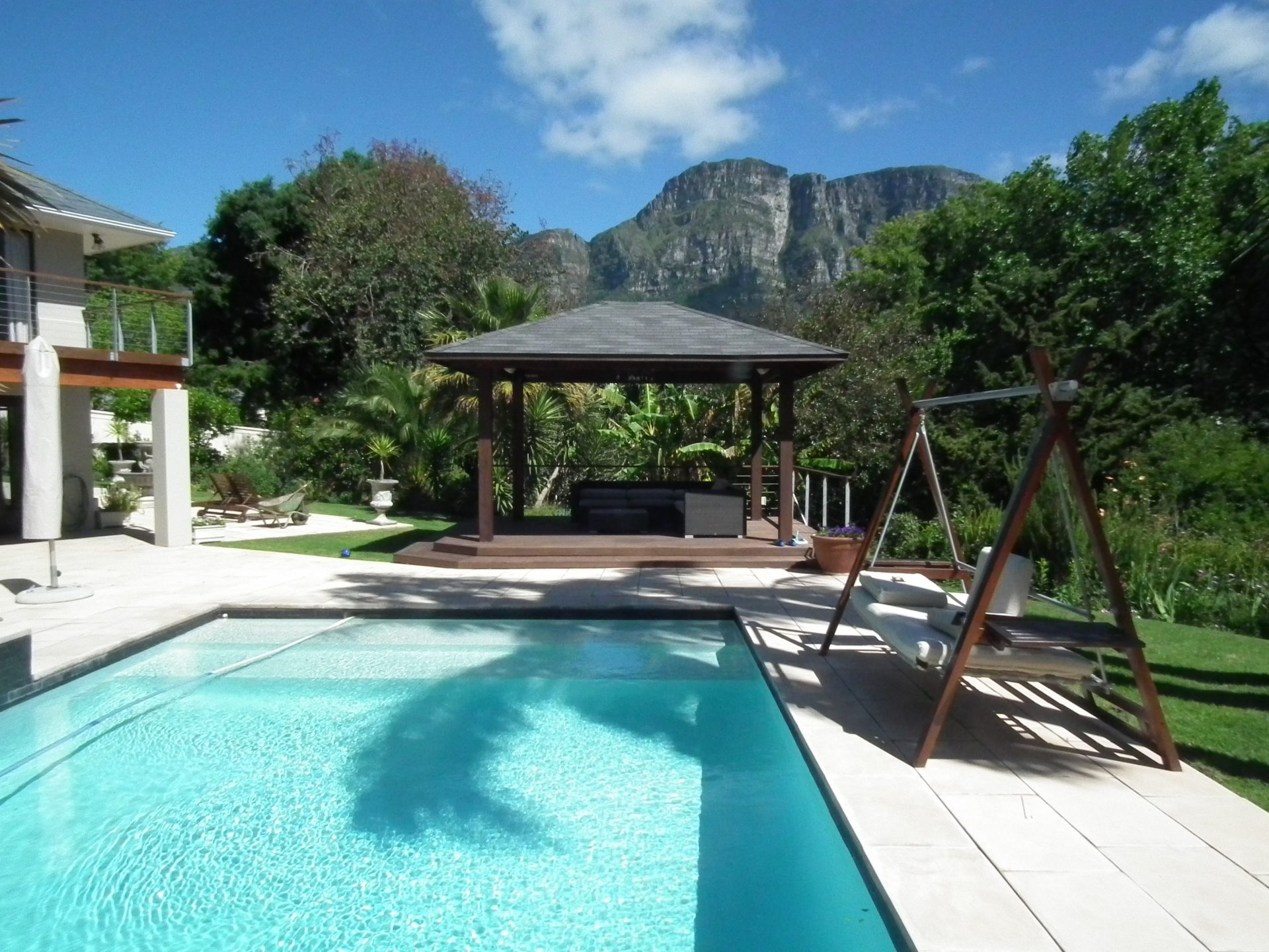 large pool area overlooking a mountain and clouds