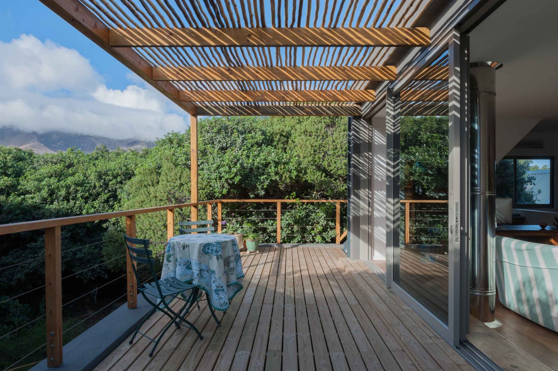 Natural family residence: spacious interior with elegant design, minimalist architectural details, and situated within a milkwood forest, creating a tranquil ambiance.